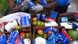 Workers fill boxes of food from the Second Harvest Food Bank of Central Florida to be distributed to needy families at a mobile food drop event at the Impact Outreach Ministry on April 6, 2020 in Orlando, Florida, US. While donations are down, many food banks across the country are scrambling to keep up with a skyrocketing demand for food due to job losses as businesses furlough workers due to the COVID-19 pandemic.
(Photo by Paul Hennessy/NurPhoto via Getty Images)