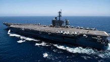 In this handout released by the U.S. Navy, The aircraft carrier USS Theodore Roosevelt (CVN 71) transits the Pacific Ocean.