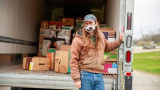 In this April 13, 2020, file photo, a driver from Hoosier Hills Food Bank delivers food at Pantry 279 to help those experiencing food insecurity during the COVID-19/coronavirus stay-at-home order. Hoosiers have been ordered to only travel for essential needs.