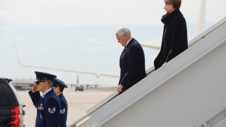 Vice President Mike Pence, center, walks off Air Force Two with Secretary of the Air Force Barbara Barrett at Peterson Air Force Base before Pence gives a graduation address at the Air Force Academy on April 18, 2020 in Colorado Springs, Colorado.
