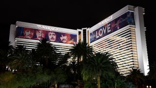 Building wraps for the “The Beatles LOVE by Cirque du Soleil” show are shown on the exterior of The Mirage Hotel & Casino