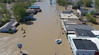 Aerial view of main street that is flooded after water from the Tittabawassee River breached a nearby dam on May 20, 2020 in Sanford, Michigan. Thousands of residents have been ordered to evacuate after two dams in Sanford and Edenville collapsed causing water from the Tittabawassee River to flood nearby communities.