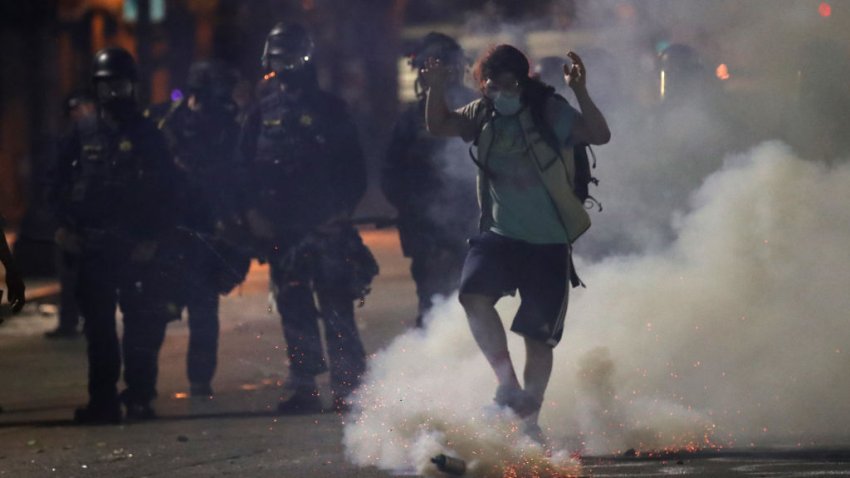 OAKLAND, CALIFORNIA – MAY 29: A demonstrator kicks a tear gas canister that was deployed by police officers during a protest sparked by the death of George Floyd while in police custody on May 29, 2020 in Oakland, California. Earlier today, former Minneapolis police officer Derek Chauvin was taken into custody for Floyd’s death. Chauvin has been accused of kneeling on Floyd’s neck as he pleaded with him about not being able to breathe. Floyd was pronounced dead a short while later. Chauvin and 3 other officers, who were involved in the arrest, were fired from the police department after a video of the arrest was circulated. (Photo by Justin Sullivan/Getty Images)