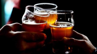 In this Feb. 7, 2014, file photo, Russian River Brewing Company customers clink their glasses while drinking the newly released Pliny the Younger triple IPA beer in Santa Rosa, California.
