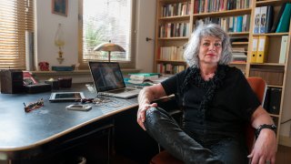 Woman posing by her desk at home office