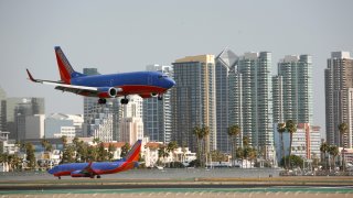 A plane lands at San Diego International Airport