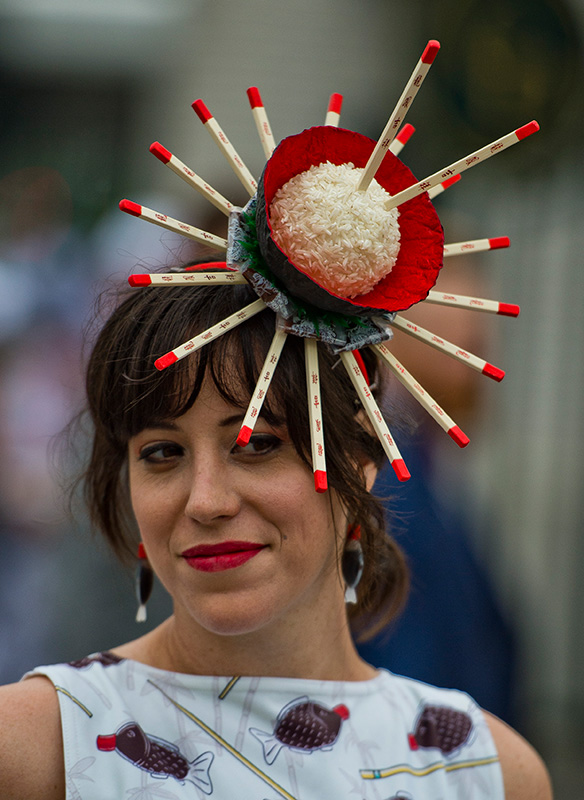 A woman wears a hat designed after a bowl of rice on Kentucky Derby Day at Churchill Downs on May 5, 2018 in Louisville, Kentucky.