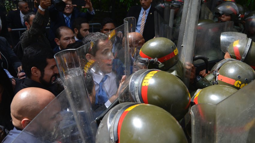 National Assembly President Juan Guaido, Venezuela’s opposition leader, is blocked by National Guards from entering the compound of the Assembly, where he was to lead a session to elect new Assembly leadership in Caracas, Venezuela, Sunday, Jan. 5, 2020. With Guaido and his allies stuck outside, a rival slate headed by lawmaker Luis Parra swore themselves in as leaders of the single-chamber legislature.