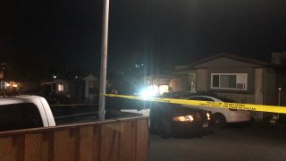 Police with yellow tape outside residence