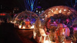 People Dining Inside a Dome at a special pop-up restaurant experience called Dining With a View