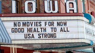 In this April 1, 2020, file photo, the marquee for the Iowa Theater, closed in response to the coronavirus outbreak, is seen on John Wayne Drive in Winterset, Iowa.