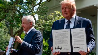 U.S. President Donald Trump and Mexican President Andres Manuel Lopez Obrador hold up a joint declaration during a joint press conference in the Rose Garden of the White House on July 8, 2020, in Washington, D.C.