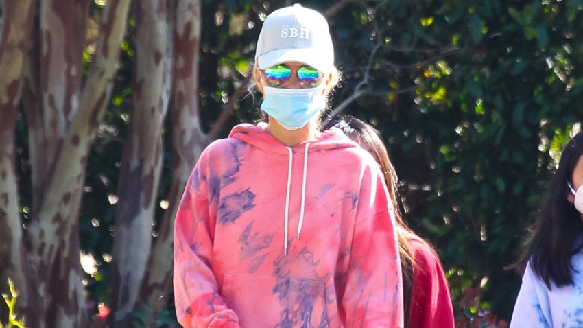 In this April 3, 2020, file photo, Laeticia Hallyday walks her dogs in Los Angeles, California.