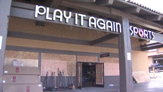 A Play it Again Sports store in the La Mesa Springs Shopping Center days after looters and rioters ransacked its shelves and set fires inside.