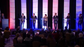 Candidates on debate stage.