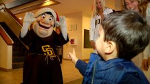 The San Diego Padres mascot greets a kid at Rady Children's Hospital