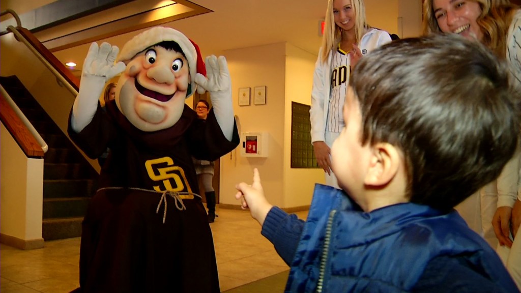 The San Diego Padres mascot greets a kid at Rady Children's Hospital