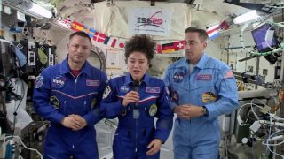 In this April 10, 2020 file image from video made available by NASA, U.S. astronaut Jessica Meir speaks, accompanied by Andrew Morgan and Chris Cassidy, during a news conference held by the American members of the International Space Station.