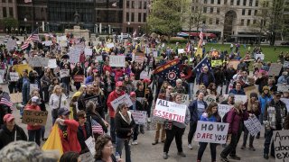 Demonstrators protest statewide lockdown measures, which were implemented to prevent the spread of the novel coronavirus, outside the Ohio Statehouse in Columbus, Ohio, May 1, 2020.