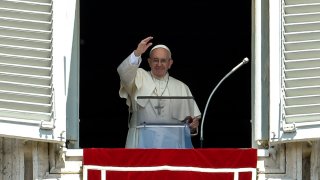 In this Aug. 7, 2016, file photo, Pope Francis waves to the crowd from the window of the apostolic palace overlooking St Peter's square during his Angelus prayer, in the Vatican City.