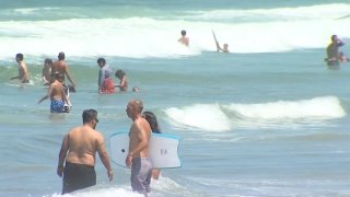 Beachgoers frolic on San Diego shores during the Fourth of July weekend.