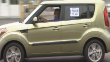 A county employee takes part in a vehicle caravan demonstration at the County Administration Building on Monday, May 18, 2020.