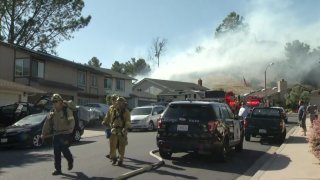 Smoke billows from a brush fire in the Bay Ho neighborhood on June 14, 2020.