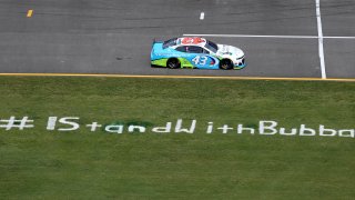 Bubba Wallace, driver of the #43 Victory Junction Chevrolet, drives past the #IStandWithBubba stencil on the field prior to the NASCAR Cup Series GEICO 500 at Talladega Superspeedway on June 22, 2020 in Talladega, Alabama. A noose was found in the garage stall of NASCAR driver Bubba Wallace at Talladega Superspeedway a week after the organization banned the Confederate flag at its facilities.