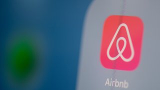 This photo illustration dated July 24, 2019, shows the logo of the online booking application Airbnb on the screen of a tablet.