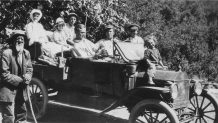 Harrison poses with a carload of visitors traveling in the Bailey stage in 1918.