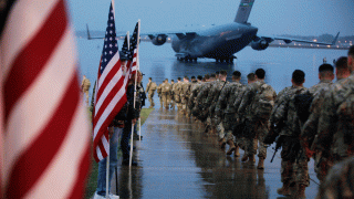 This photo provided by the U.S. Army, paratroopers assigned to 1st Brigade Combat Team, 82nd Airborne Division walk as they prepare equipment and load aircraft bound for the U.S. Central Command area of operations from Fort Bragg, N.C., Saturday, Jan. 4, 2020.