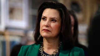In this March 18, 2019, file photo, Michigan Gov. Gretchen Whitmer listens to Democratic presidential candidate Sen. Kirsten Gillibrand, D-N.Y., in Clawson, Mich. Whitmer is moving to make Michigan the first state to ban flavored e-cigarettes.