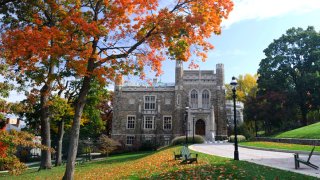 Lehigh University is shown behind trees in autumn.