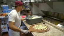 Chef preparing pizza in Poway