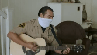 San Diego Sheriff's Department Deputy Roland Garza serenades senior citizens as part of the department's You Are Not Alone program.