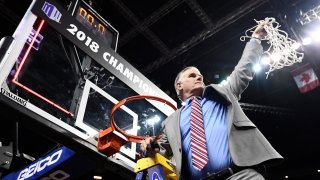Brian Dutcher cutting down basketball net
