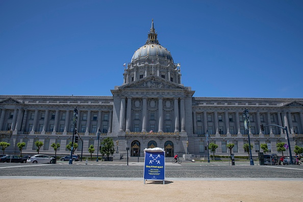 A warning board reading “Stay 6 feet apart” is seen set at the empty square in front of the City Hall amid the coronavirus epidemic on May 28, 2020 in San Francisco, California. (Photo by Liu Guanguan/China News Service via Getty Images)