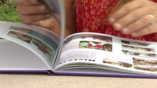 A Creative Performing and Media Arts Middle School student flipping through the yearbook.