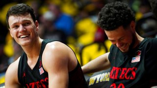 San Diego State forward Yanni Wetzell (5) and guard Jordan Schakel (20) laugh on the bench after a teammate accidentally stepped out of bounds while not under pressure during an NCAA college basketball game against Wyoming on Wednesday, Jan. 8, 2020, in Laramie, Wyo. (Nadav Soroker/Laramie Boomerang via AP)
