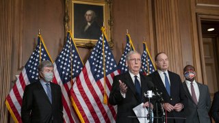 Senate Majority Leader Mitch McConnell, second left, speaks during a press conference at the U.S. Capitol in Washington, D.C., July 27, 2020.