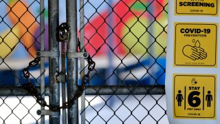 A chain-link fence lock is seen on a gate at a closed Ranchito Elementary School in the San Fernando Valley section of Los Angeles on Monday, July 13, 2020. Amid spiking coronavirus cases, Los Angeles Unified School District campuses will remain closed when classes resume in August, Superintendent Austin Beutner said Monday.