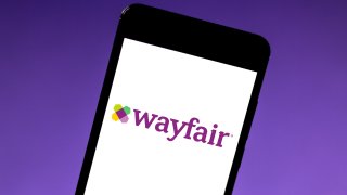 In this photo illustration the Wayfair logo is seen displayed on a smartphone