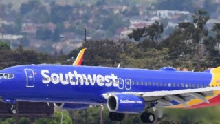 A Southwest Airlines airplane comes in for a landing at Los Angeles International Airport on May 12, 2020 in Los Angeles, California. - The airline and travel industries have been devasted by the coronavirus pandemic as Stay-at-Home orders in Los Angeles, due to end in mid-May, have been extended to July.