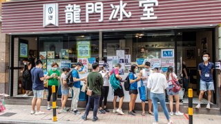 Hong Kong voters queue up at a restaurant to cast their votes.