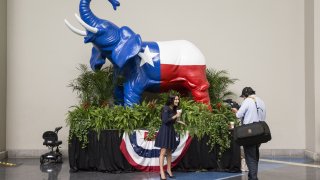 Members of the media film a segment in front of a Texas flag themed elephant statue during the 2016 Texas Republican Convention in Dallas, Texas, U.S., on Saturday, May 14, 2016.