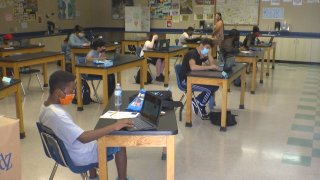 Students sit at desks in a classroom