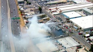 A plume of smoke over a freeway in El Cajon