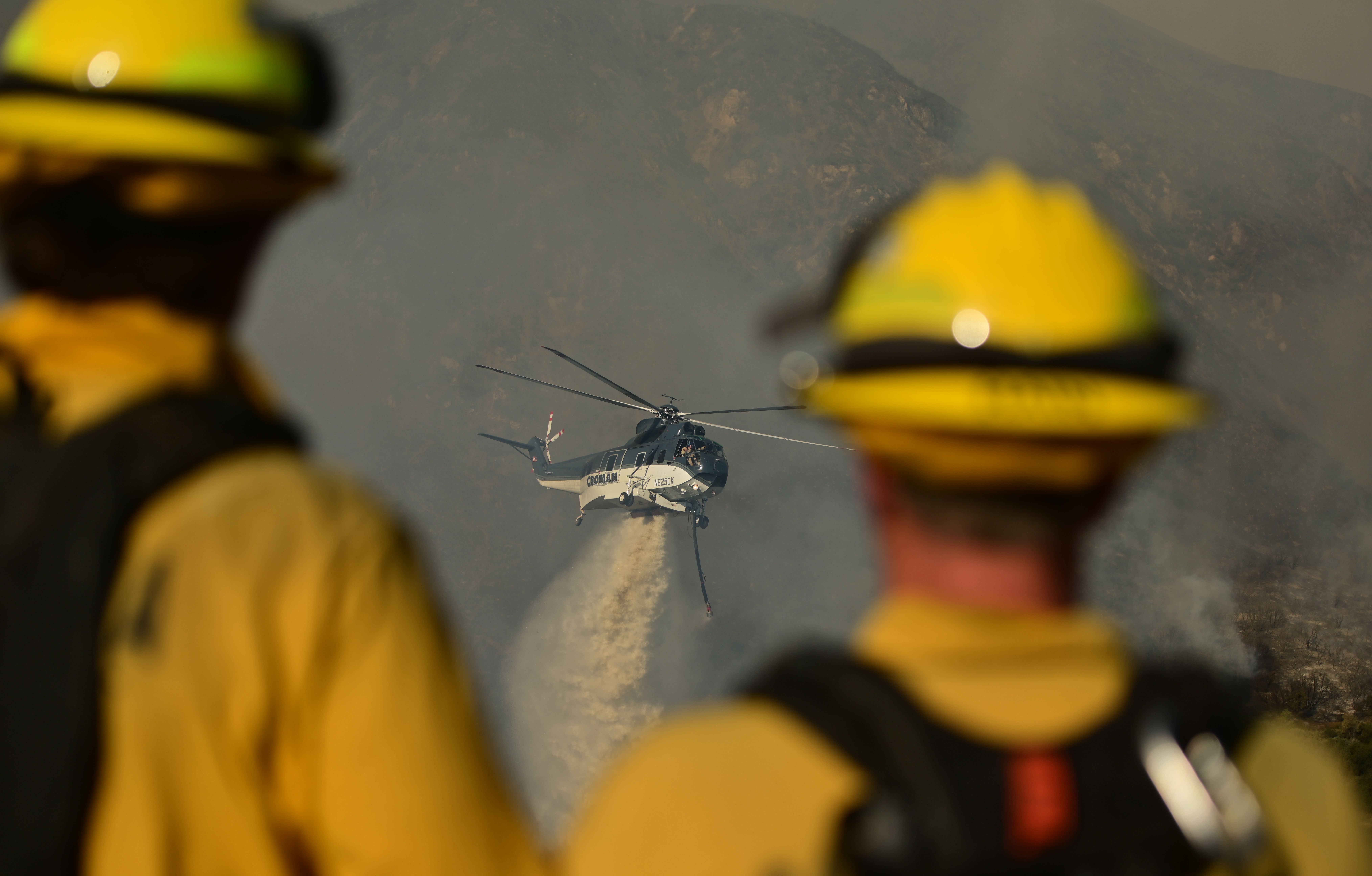 A helicopter drops water on hot spots during the Apple fire near Banning, California on August 1, 2020. – 4,125 acres have burn in Cherry Valley, about 2,000 people have received evacuation orders in the afternoon of August 1.<br />nAround 8PM the fire spread to 12,000 acres. (Photo by JOSH EDELSON / AFP) (Photo by JOSH EDELSON/AFP via Getty Images)