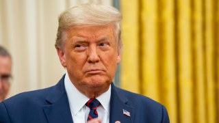 In this Aug. 4, 2020, file photo, President Donald Trump participates in the swearing in of General Charles Q. Brown as the incoming Chief of Staff of the Air Force, in the Oval Office of the White House in Washington, D.C.