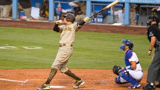 San Diego Padres third baseman Manny Machado (13) hits a grand slam in third inning of a MLB game between the San Diego Padres and the Los Angeles Dodgers on August 10, 2020 at Dodger Stadium in Los Angeles, CA. The 2020 regular season has been shortened to 60 games due to the COVID-19 Pandemic. (Photo by Brian Rothmuller/Icon Sportswire via Getty Images)